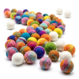 May include: A collection of numerous small, round felt balls arranged in a winding path. The spheres feature a variety of solid colours and multicoloured blends, including shades of pink, blue, orange, green, yellow, and purple, alongside several plain white balls.