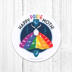 May include: A round sticker with a colorful moth design. The moth's wings are in rainbow colors, and the sticker has the text "HAPPY PRIDE MOTH!" in a circular pattern. The background is white.