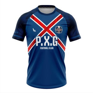May include: A blue football jersey with a red and white cross design across the chest. The jersey features the text "P.X.G FOOTBALL CLUB" in white, along with a team logo. The sleeves are navy blue with a subtle pattern.