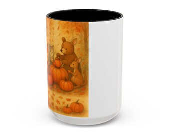 May include: White ceramic mug with a black interior and a wraparound illustration of woodland animals gathered around pumpkins in an autumn scene. The artwork features a bear, a kangaroo, and a cat.