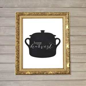 May include: A black and white printable art print with a silhouette of a pot and the text "happy harvest".