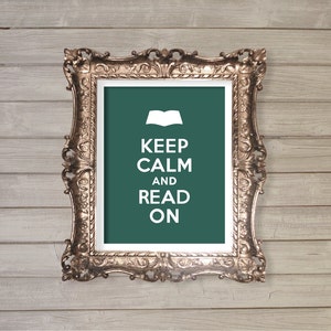 May include: A gold-colored ornate frame with a green background and white text that reads "Keep Calm and Read On". An open book icon is above the text.