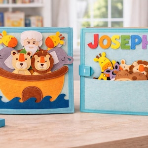 May include: Two light blue felt books with colorful animal and biblical illustrations. One book features an ark with lions, elephants, and a man. The other book has the name "JOSEPH" in colorful letters and a pocket with various animals.
