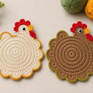 May include: Two round crochet coasters shaped like chickens, one in cream with a yellow border and one in brown with a green border. Each features a red comb, a yellow beak, and a black and white plastic eye. The circular bodies have a textured stitch pattern.