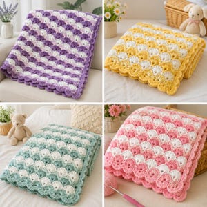 May include: A collection of four crocheted blankets featuring a scalloped shell stitch pattern. Each blanket is crafted in a two-tone color scheme, including purple and white, yellow and white, sage green and white, and pink and white.