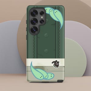 May include: A dark green smartphone case featuring a vertical textured pattern and a series of light green, ghost-like figures. A white horizontal band at the bottom displays a small, dark brown creature with large eyes and a white mouth.