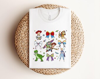 Koszulka Coquette z motywem Toy Story w kolorach Comfort Colors, koszulka Coquette z kokardą, koszulka Disney Toy Story, koszulka Disney Friends, koszulka Woody Buzz Jessie Hamm T-Rex