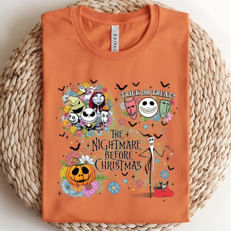 May include: Orange t-shirt featuring characters and imagery from The Nightmare Before Christmas. The design includes Jack Skellington, Sally, and other characters, along with the text "Trick or Treat?" and "The Nightmare Before Christmas."