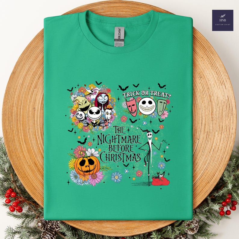 May include: A green t-shirt featuring a colorful graphic from "The Nightmare Before Christmas." The design includes Jack Skellington, Sally, Zero, and other characters, along with the text "Trick or Treat?" and "The Nightmare Before Christmas."