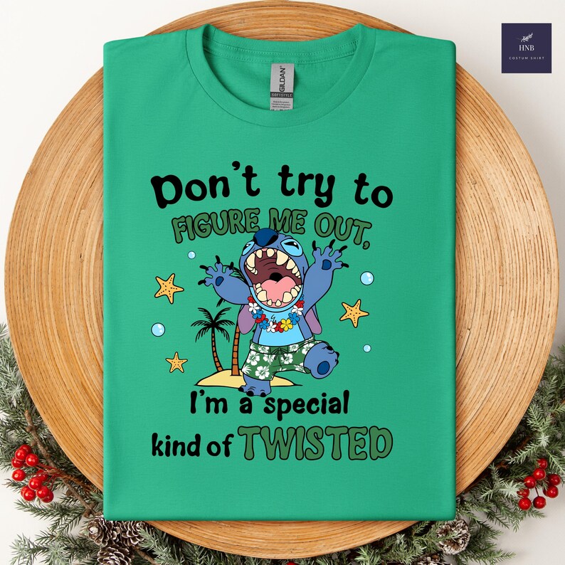 May include: A green t-shirt featuring the character Stitch with the text "Don't try to figure me out, I'm a special kind of twisted." Stitch is depicted with a wide open mouth, wearing a floral lei and tropical shorts. The design includes palm trees, stars, and bubbles.