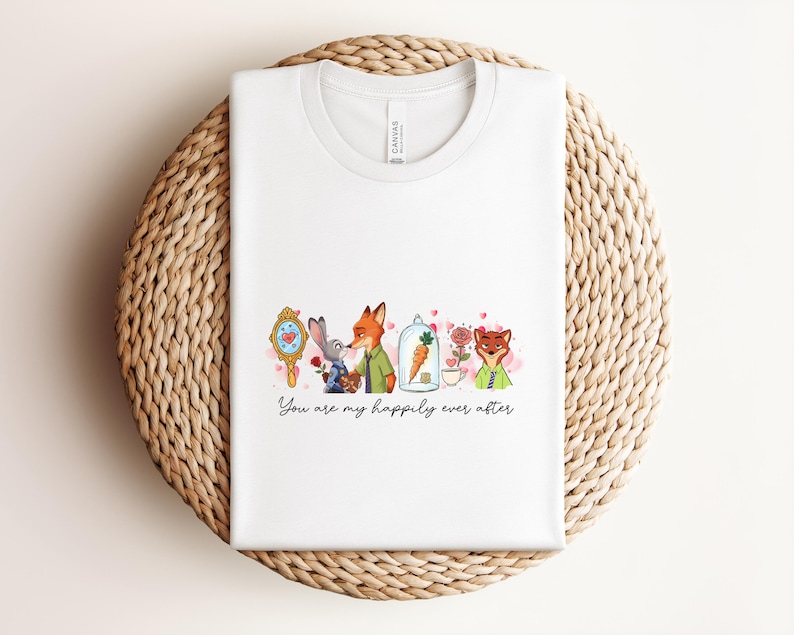 May include: White t-shirt with a watercolor illustration featuring characters from a popular animated movie. The design includes a mirror, a rabbit, a fox, a carrot in a glass dome, and a rose. The text "You are my happily ever after" is written below the illustration.