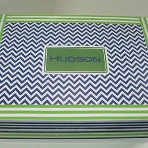 May include: A blue and white chevron patterned gift box with a green border and a green label that says "HUDSON".