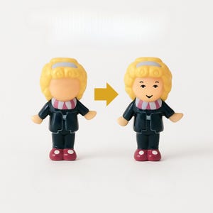May include: Two small, plastic figurines of a person with blonde hair and a dark suit. One figurine has a blank face, while the other has a smiling face. A yellow arrow points from the blank face to the smiling face.