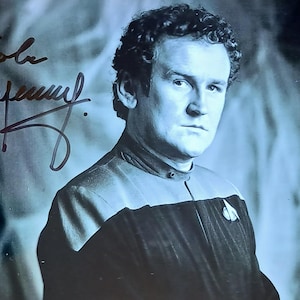 May include: Black and white photograph of Colm Meaney as Chief Operations Officer Miles O'Brien from Star Trek: Deep Space Nine. The photo includes an autograph and the Star Trek logo.