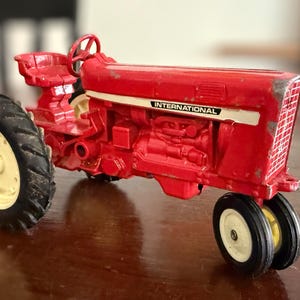 May include: A rustic wooden sign with the text "Welcome to our home" in white lettering. The sign features a distressed finish and a simple, inviting design, perfect for front door decor.