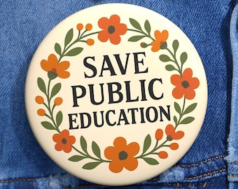 May include: A round, cream-colored button with the text "SAVE PUBLIC EDUCATION" in black, surrounded by orange flowers and green leaves. The button is pinned to a blue denim jacket.