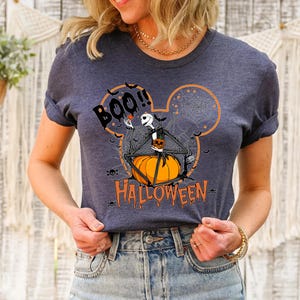a woman wearing a mickey mouse halloween t - shirt