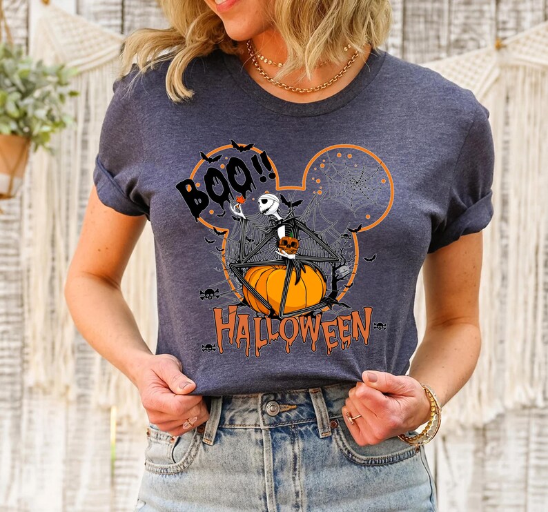 a woman wearing a mickey mouse halloween t - shirt