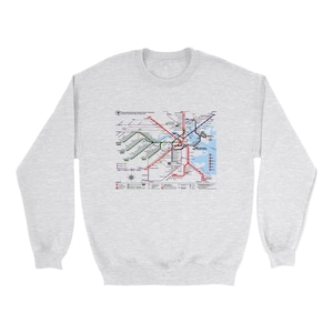 May include: A gray sweatshirt with a graphic print of the MBTA subway map of Boston, Massachusetts. The map shows the different lines and stations of the subway system.