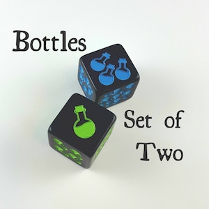 May include: Two black dice with blue and green potion bottle designs. The dice are labeled "Bottles" and "Set of Two". The dice are on a white background.