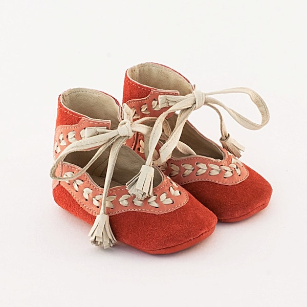 Coral pink leather baby shoes with beige leather stitch embellishment