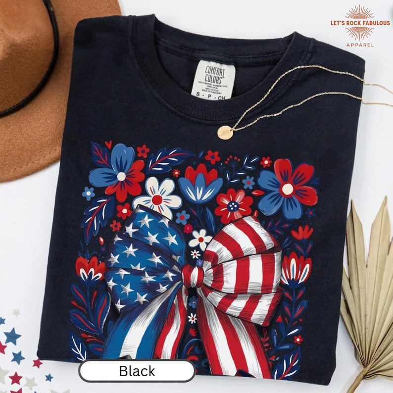 Boho floral American flag bow t-shirt on Comfort Colors 1717 unisex tee. Patriotic 4th of July shirt for women featuring red white and blue bow with floral design. Available in sizes S, M, L, XL, 2XL, 3XL, 4XL and multiple color options including ivory, white, navy, pepper, blossom, and chambray. Perfect America 250th Anniversary tee, Independence Day outfit, summer BBQ, and casual Americana style.