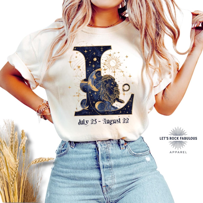 Leo Zodiac Sign celestial lion graphic on a Comfort Colors 1717 t-shirt featuring gold moon phases, stars, and cosmic artwork with July 23–August 22 text. Astrology-inspired graphic tee available in multiple colors and sizes S to 4XL. Perfect gift for Leo birthdays, horoscope lovers, and boho celestial fashion.