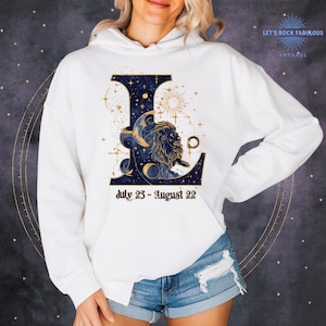 Leo Zodiac Sign celestial lion graphic on a soft Gildan hoodie featuring gold moon phases, stars, and cosmic artwork with July 23–August 22 text. Astrology-inspired graphic tee available in multiple colors and sizes S to 3XL. Perfect gift for Leo birthdays, horoscope lovers, and boho celestial fashion.