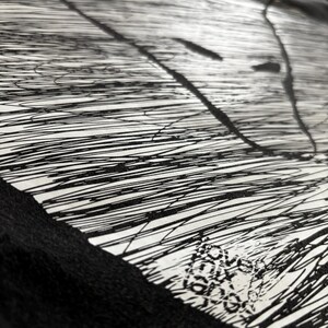 May include: Abstract black and white artwork featuring a pattern of parallel lines and ink splatters. The design has a textured appearance, with a combination of thick and thin lines. The artwork is on a white background with a black border.
