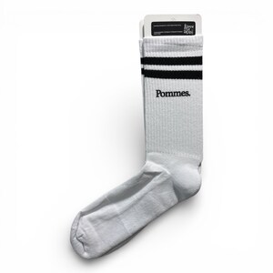 May include: A white crew sock featuring two horizontal black stripes at the top cuff and the word Pommes. printed in black text below the stripes. The sock is attached to a white cardboard header card with small black text at the top.