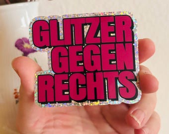 May include: A rectangular sticker with a holographic, glittery finish featuring the bold, black-outlined magenta text "GLITZER GEGEN RECHTS" arranged in three lines. The sticker has a die-cut shape that follows the contour of the lettering.