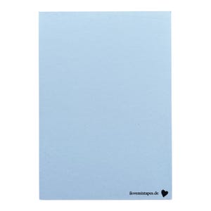 May include: A rectangular light blue card with a smooth, matte finish. In the bottom right corner, the text "ilovemixtapes.de" is printed in a small, black, sans-serif font, followed by a small, solid black heart icon.