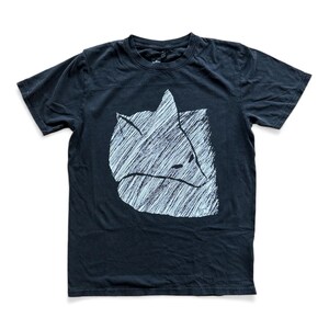 May include: Black t-shirt featuring a white, stylized fox graphic. The fox design is created with a series of parallel lines, giving it a textured appearance. The shirt has short sleeves and a crew neck.