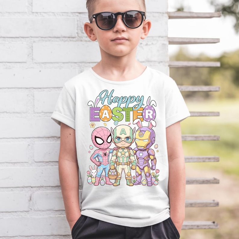 A young boy wearing a white t-shirt with a colorful graphic design featuring cartoon characters and Easter-themed elements.
