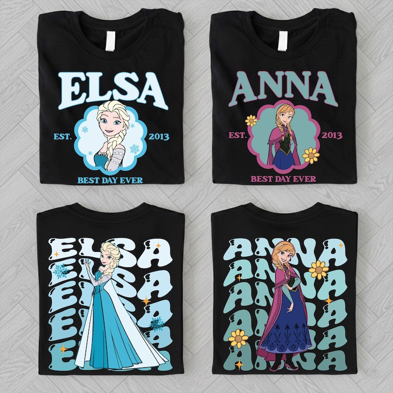 four black t-shirts with the character Elsa from the Disney movie Frozen. Each t-shirt features a different design, including a repeated pattern of the character's name and the year 2013, as well as a different illustration of Elsa.