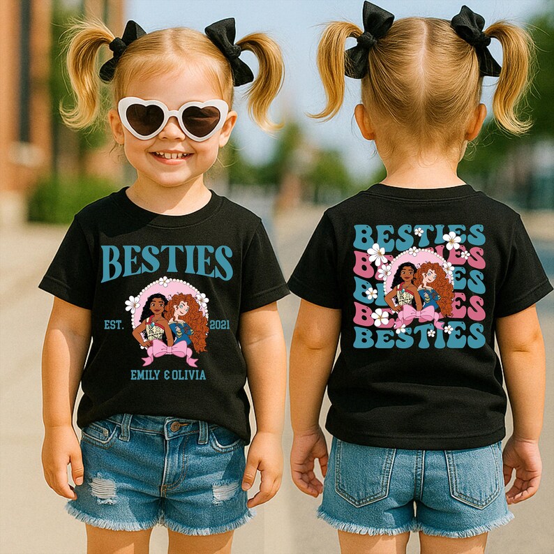 A young girl wearing a black t-shirt with a graphic design and a heart-shaped pair of sunglasses, standing outdoors.