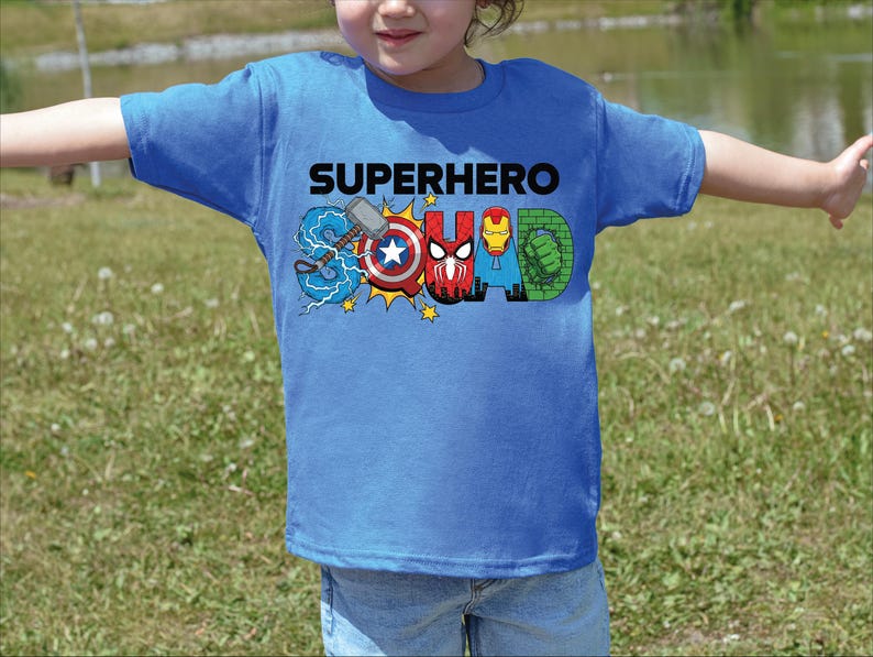 A child wearing a blue t-shirt with the text "SUPERHERO SQUAD" printed on it, featuring various superhero characters.