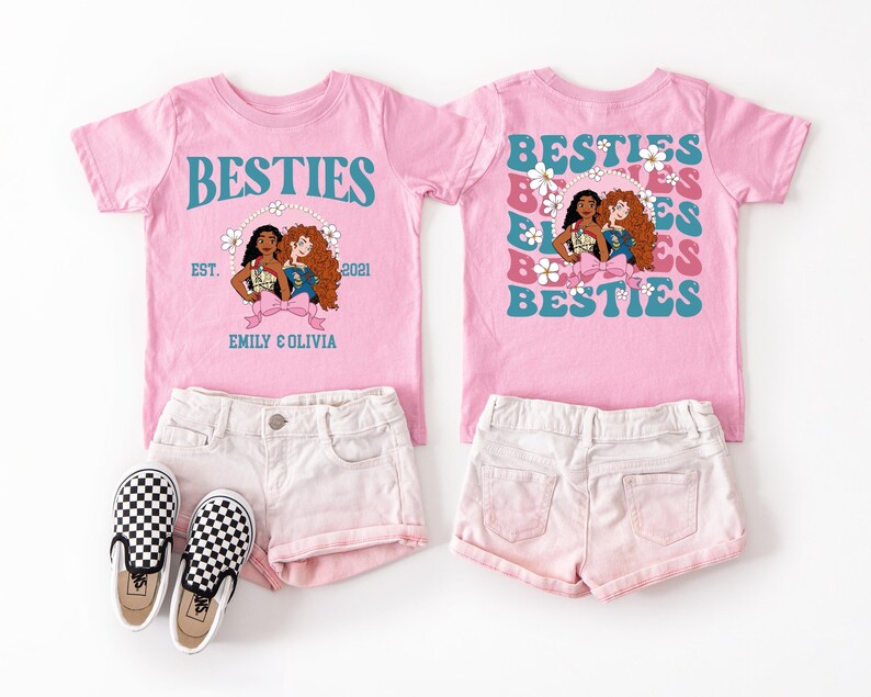 a pink t-shirt with a graphic design featuring three cartoon girls, along with a pair of white shorts and black and white checkered shoes.
