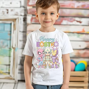 A young boy wearing a white t-shirt with a colorful Easter-themed graphic design featuring cartoon characters.