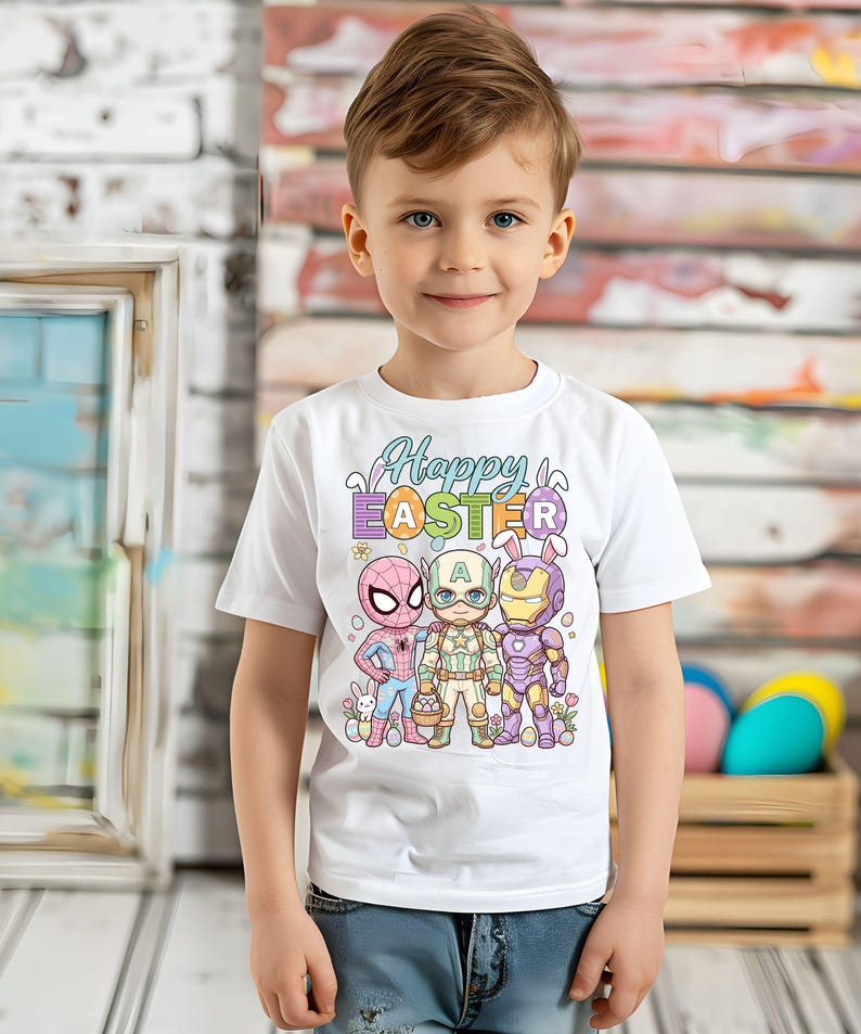 A young boy wearing a white t-shirt with a colorful Easter-themed graphic design featuring cartoon characters.