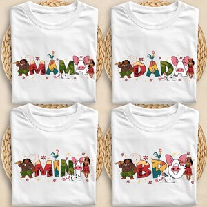 four white t-shirts with colorful text and illustrations, including characters and animals.