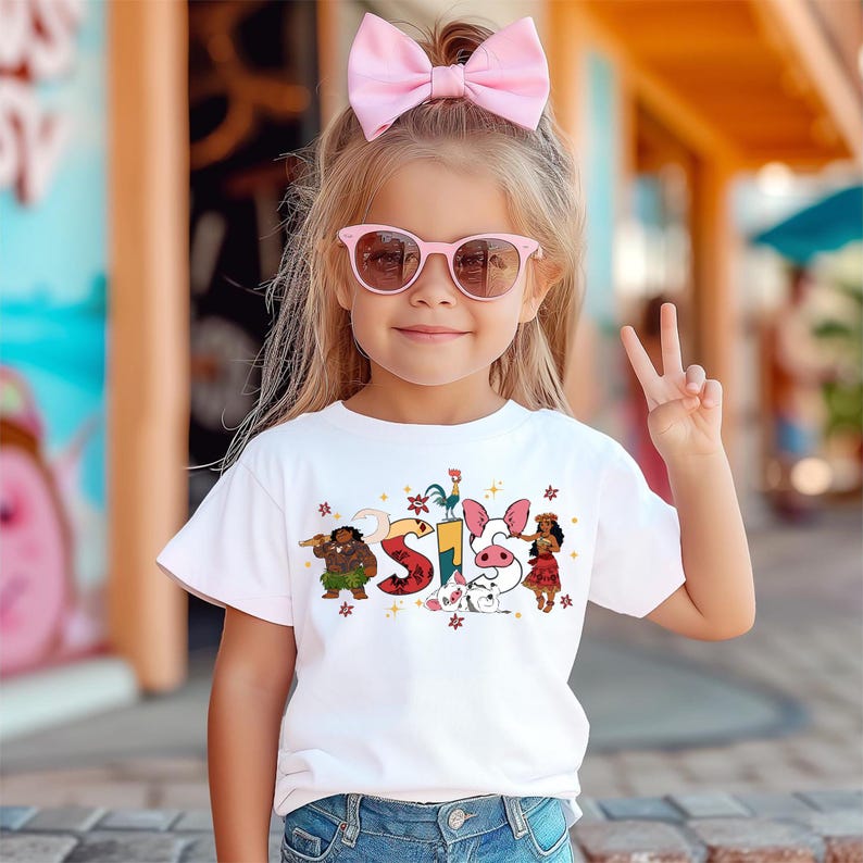 A young girl wearing a white t-shirt with a cartoon character design and pink sunglasses is making a peace sign.