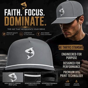 May include: A grey baseball cap featuring a white graphic of a fish with a cross symbol. The cap includes a white rope detail across the base of the crown and an adjustable snapback closure. Text on the image reads FAITH. FOCUS. DOMINATE.