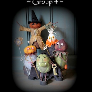 May include: A group of handmade Halloween figures, including a scarecrow, a witch, and other whimsical characters. The figures are made of fabric and have unique details. Text reads "Trick-or-Treaters ~ Group 4~" and "Original Pattern & Design by The Cheswick Company."