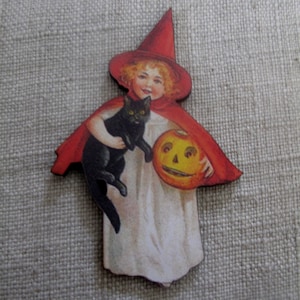 May include: A vintage Halloween-themed wooden ornament featuring a girl dressed as a witch holding a black cat and a jack-o'-lantern.