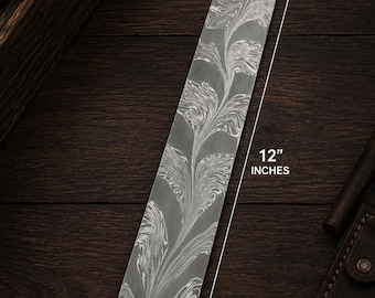 May include: A rectangular metal bar featuring a swirling, marbled pattern in shades of gray and white. The bar measures 12 inches in length and 2 inches in width, as indicated by the white dimension lines and text printed directly on the image.