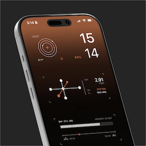 May include: A smartphone displaying a dark-themed interface with a gradient brown background. The screen shows a digital clock reading 15:14, an orbital graphic, wind speed of 2.91 mph, direction 204 SW, pressure 1021 HPA, and a day progress bar.
