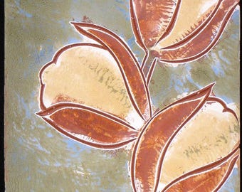 May include: A triptych of ceramic tiles featuring a floral design. Each tile displays a stylized flower with cream-colored petals and reddish-brown leaves against a textured green and blue background. A square grid and a spiral are also present.
