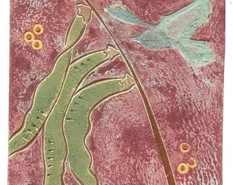 May include: Square ceramic tile with a textured, reddish-purple background. The tile features a stylized design of green bean pods, a light blue bird, and small yellow circles. A brown line curves across the tile.