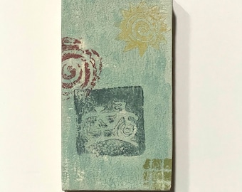 May include: Rectangular artwork with a textured, light blue background. It features a red spiral, a yellow sun, and a dark green square with a bicycle design. A small green and yellow square is in the lower right corner.